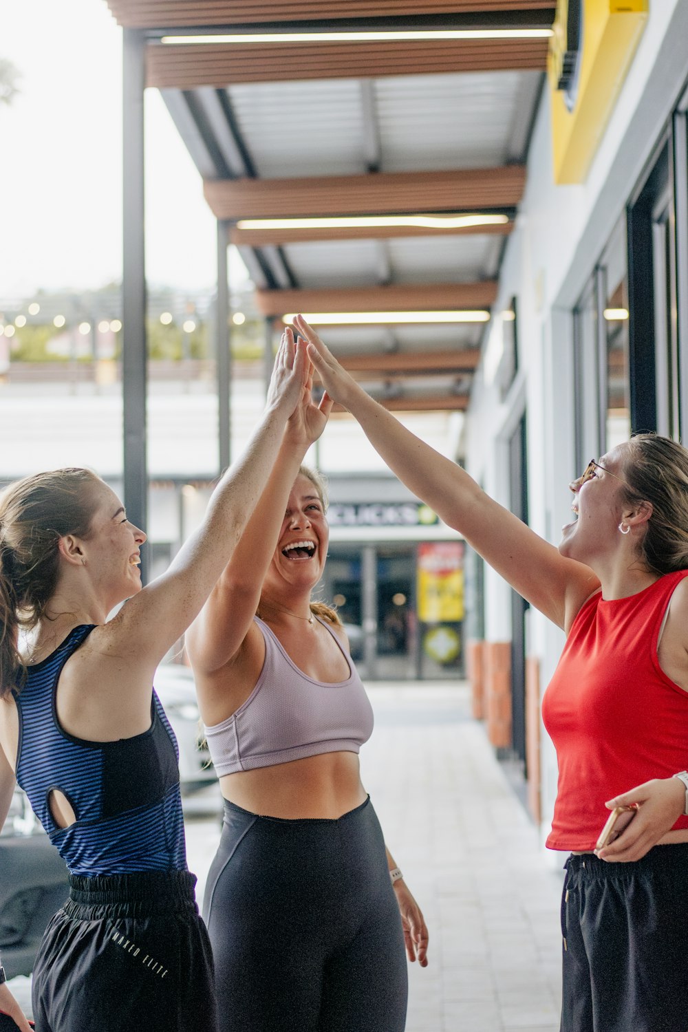 Three athletes high-fiving