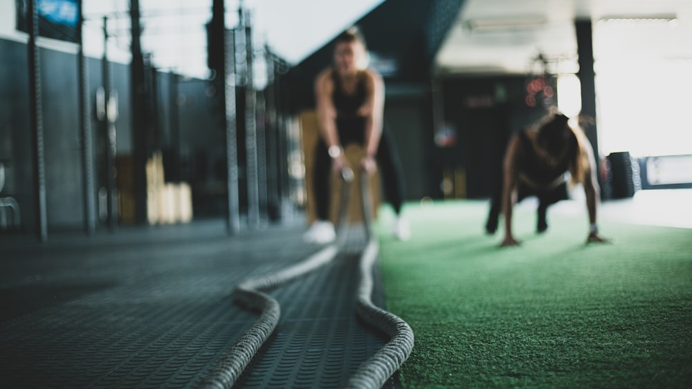 Two athletes training together on the gym floor