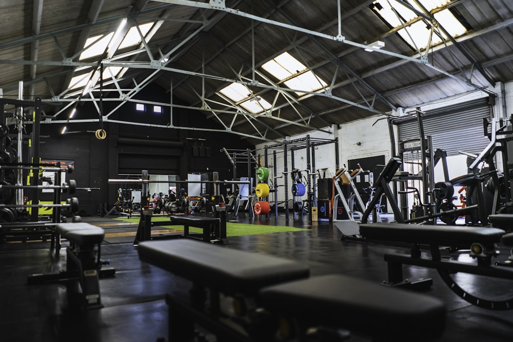Warehouse-style gym floor with weightlifting rig